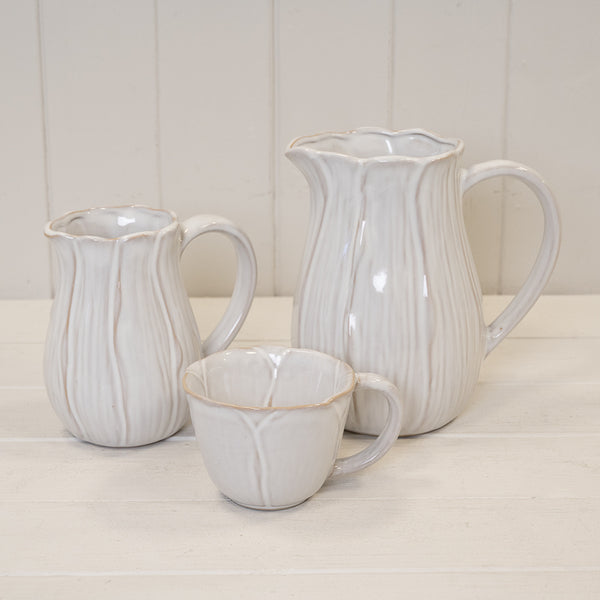 Large natural ceramic jug with petal shape design, ideal for home decor, by Satchville.