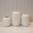 Small cream ceramic ribbed vase, Satchville home decor piece with textured ridged surface, ideal for stylish interior accents.