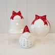 White Christmas bauble with red bow from Satchville, festive holiday decoration, shiny round ornament for Christmas tree.