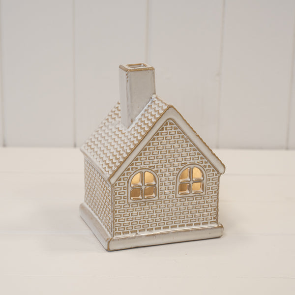 White ceramic LED light-up cottage for Christmas decoration, crafted by Satchville, featuring a cozy festive design.