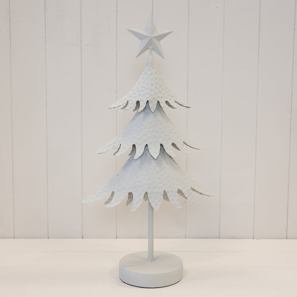 White metal extra tall Satchville Christmas tree decorated with ornaments and lights for holiday festivities.