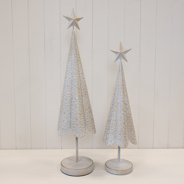 White metal Christmas trees with gold star detailing shown in two sizes