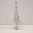 Extra-large white metal Christmas tree with gold stars and a round base.