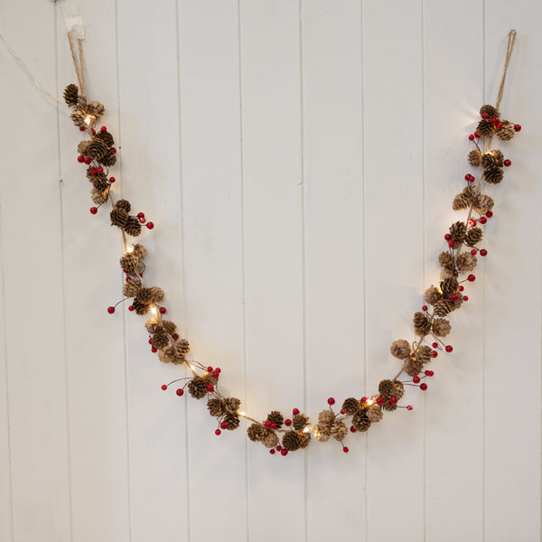 Satchville Christmas LED garland with pinecones and red berries, festive holiday decoration with warm lights and natural accents.