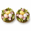 Set of two decorative pastel egg nests with pink flowers and greenery, packaging removed, studio view.