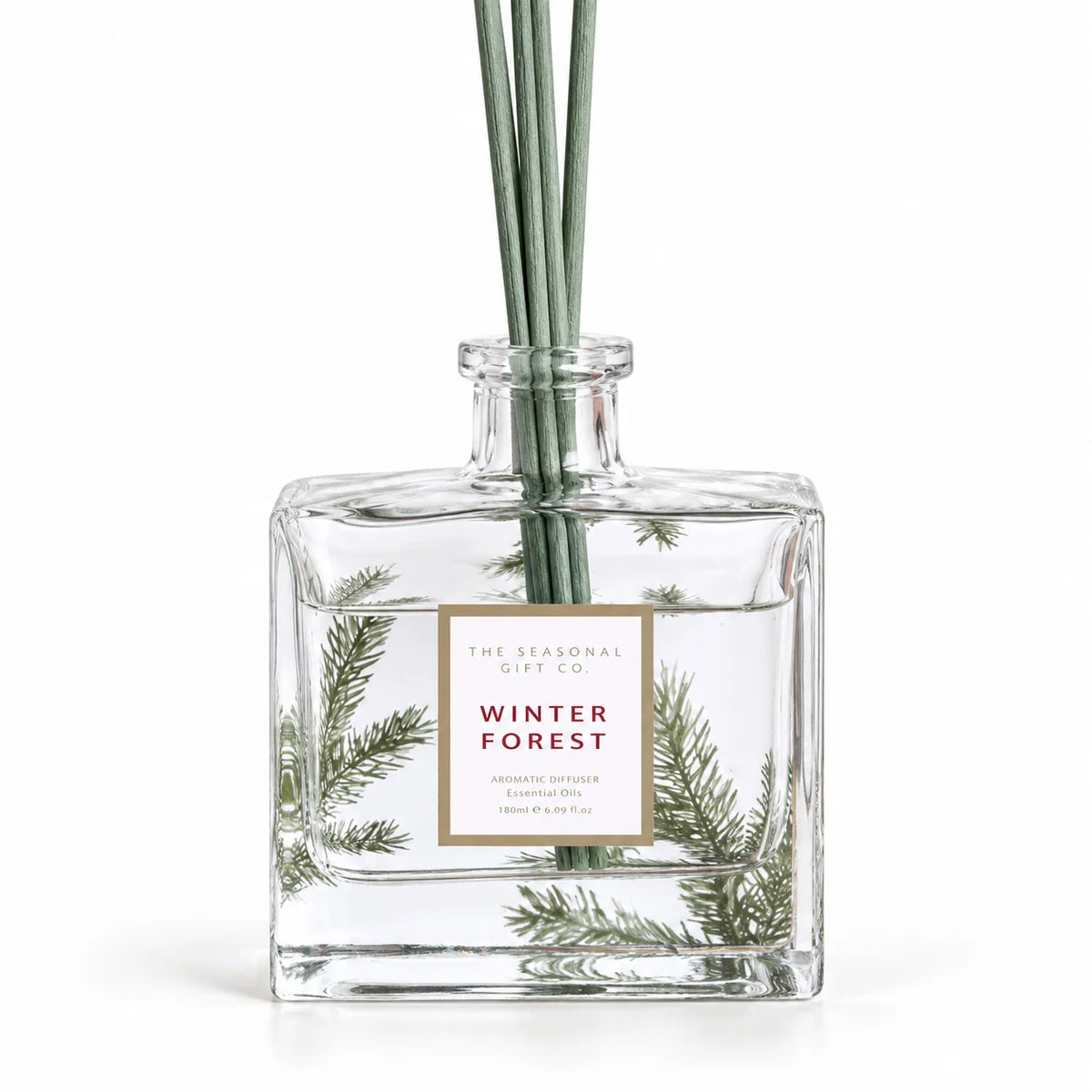 Close-up of the pine detail and Winter Forest label on the glass diffuser bottle