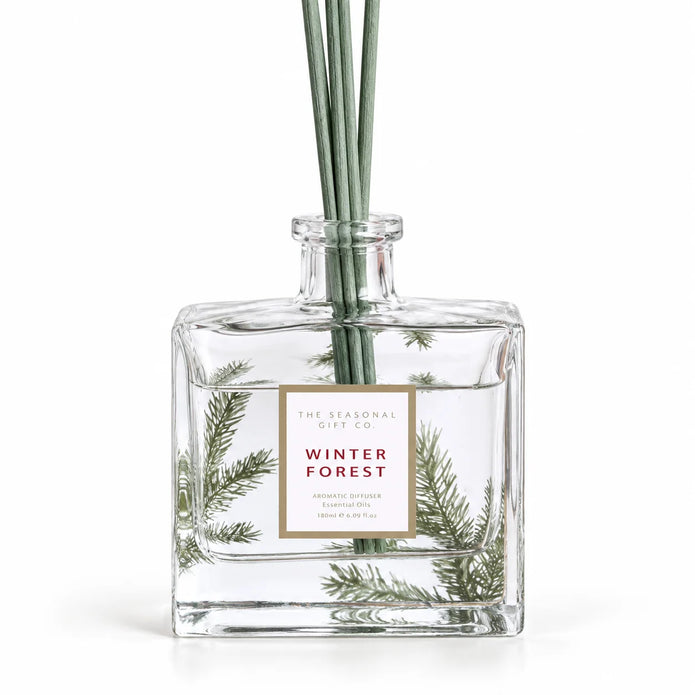 Close-up of the pine detail and Winter Forest label on the glass diffuser bottle