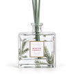 Close-up of the pine detail and Winter Forest label on the glass diffuser bottle