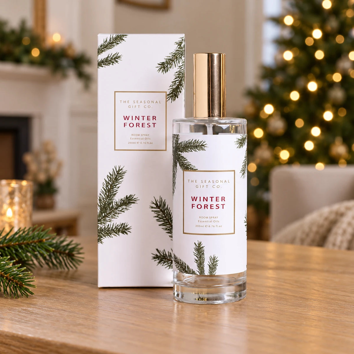 Pine Pattern Winter Forest room spray with its matching gift box on an oak console beside a Christmas tree.