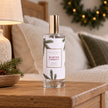 Pine Pattern Winter Forest room spray on an oak bedside table in a cosy country bedroom.