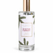 Close view of the pine-patterned Winter Forest label and clear glass bottle on a white background.