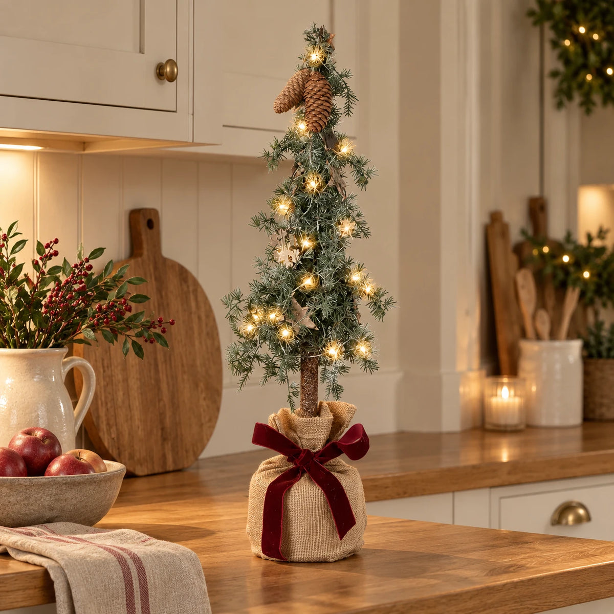 Pine spruce Christmas tree in a hessian bag on a country kitchen counter