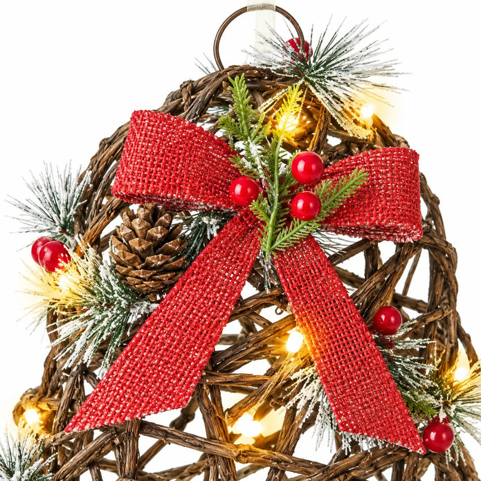 Close-up of red woven bow frosted foliage berries and lights on a rattan bell