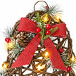 Close-up of red woven bow frosted foliage berries and lights on a rattan bell