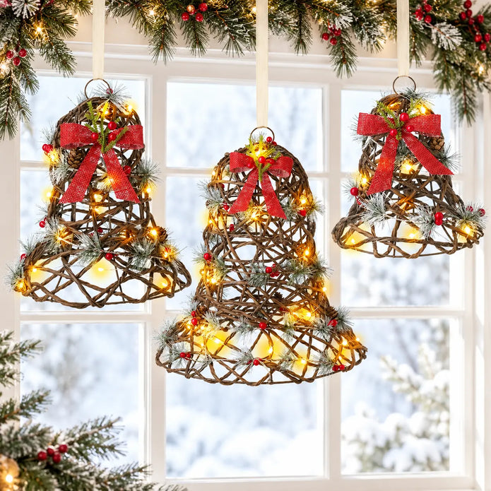 Three light up rattan Christmas bells in a festive window