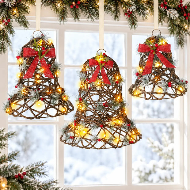 Three light up rattan Christmas bells in a festive window