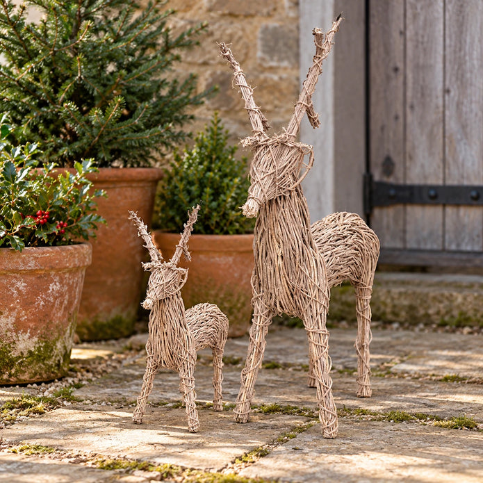 Rattan standing outdoor Christmas reindeer by Pacific Lifestyle Limited in a courtyard setting