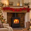180cm Red Berry Burst Luxury Garland draped across an oak Christmas mantel