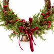 Large red berry twig Christmas wreath with pinecones, bell and bow, close-up detail