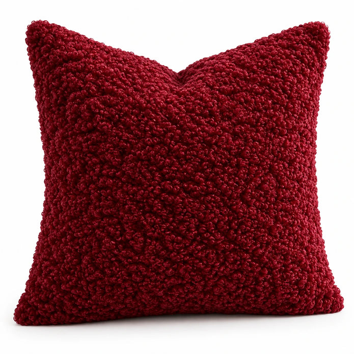 Angled studio view showing the red burgundy cushion cover’s looped bouclé texture