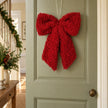 Red fluffy Christmas bow hanging ornament by Heaven Sends, featuring soft, plush texture and festive design for holiday decor.