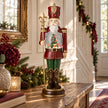 Red nutcracker LED snow globe styled on an oak console with Christmas greenery