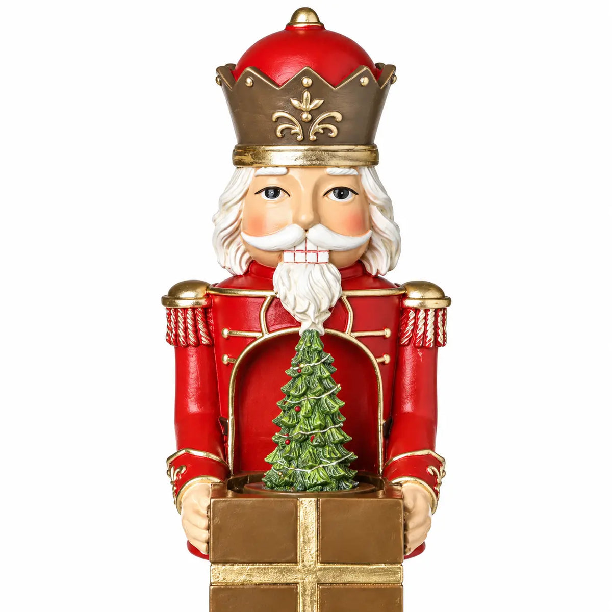 Close-up of red musical soldier crown, face, gift and small Christmas tree