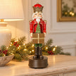 Red musical soldier Christmas decoration on pale sideboard