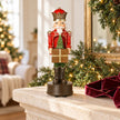 Red musical soldier Christmas decoration on stone mantel with garland