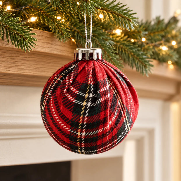 8cm red tartan pleated bauble hanging from its silver cord in a natural fir Christmas mantel garland.
