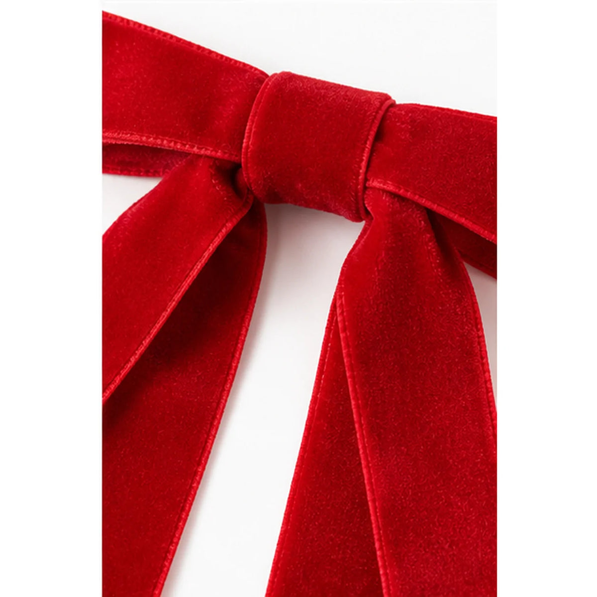 Close-up of red velvet Christmas bow ribbon texture and knot
