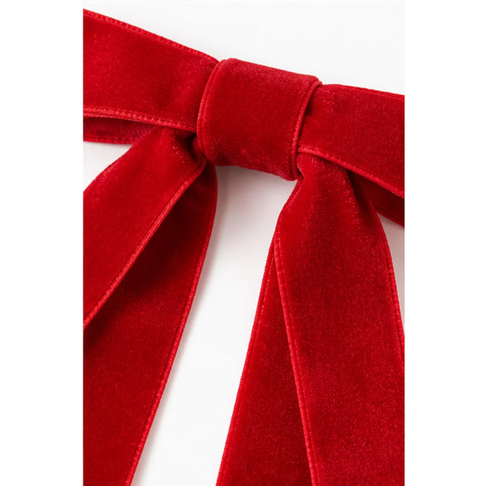 Close-up of red velvet Christmas bow ribbon texture and knot