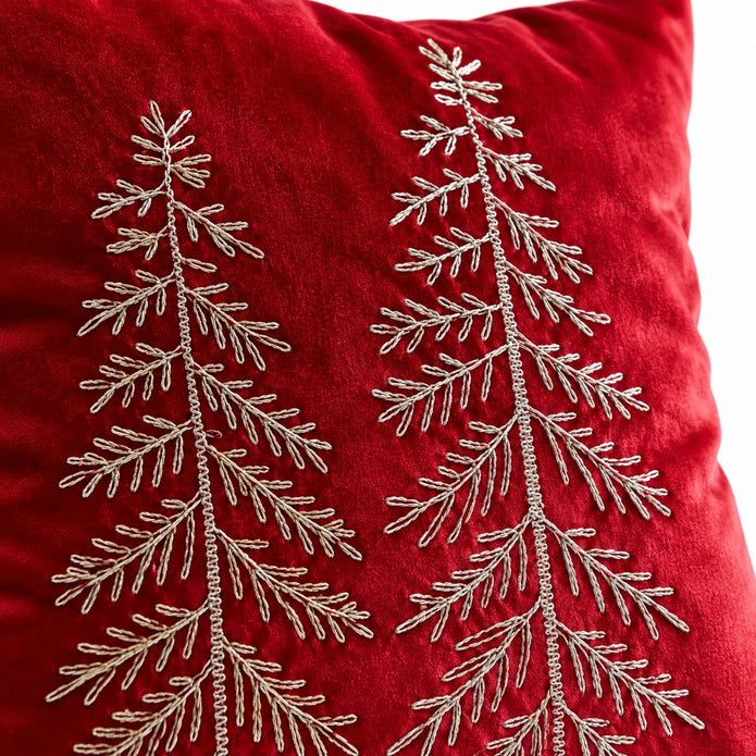 Close-up of fine metallic tree embroidery and soft red velvet cushion-cover texture