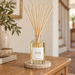Heaven Scent RHUBARB & GINGER 100ml reed diffuser styled on an oak console with natural reeds inserted.