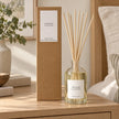 Heaven Scent RHUBARB & GINGER 100ml reed diffuser with reeds inserted beside its matching kraft gift box.