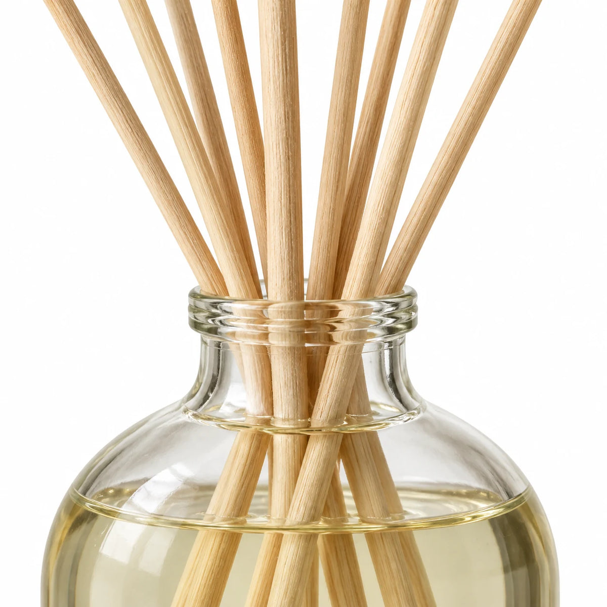 Heaven Scent RHUBARB & GINGER 100ml reed diffuser close-up of natural rattan reeds and the glass bottle neck.