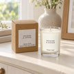 Heaven Scent Rhubarb & Ginger Small Candle, unlit with its brown kraft box on a cream console