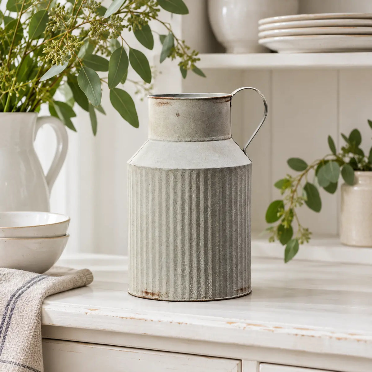 Satchville ribbed metal jug vase displayed on a spring dresser
