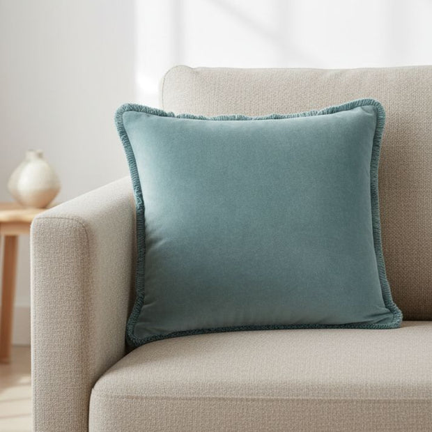 Velvet cushion cover in duck egg blue with Riva Home branding, featuring soft fabric and elegant design for cozy home decor.