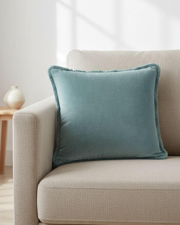 Velvet cushion cover in duck egg blue with Riva Home branding, featuring soft fabric and elegant design for cozy home decor.