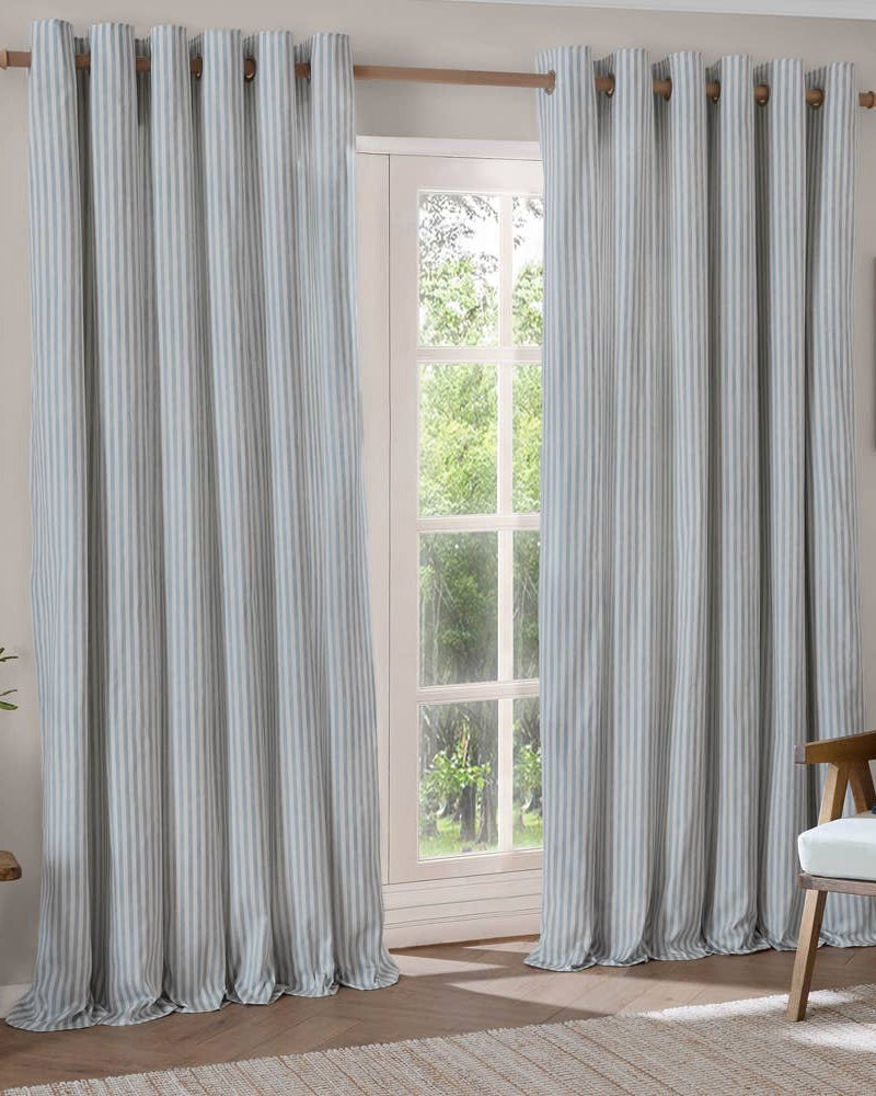 Ocean blue striped blackout eyelet curtains by Riva Home, soft furnishings, showing the fabric with bold blue and black stripes.
