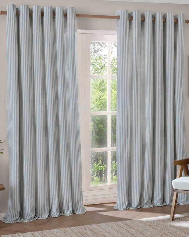 Ocean blue striped blackout eyelet curtains by Riva Home, soft furnishings, showing the fabric with bold blue and black stripes.