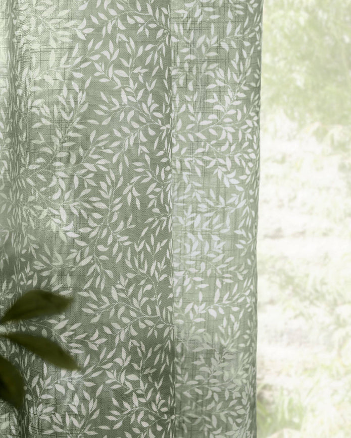 Green woven sheer voile curtain panel with yard leaf pattern, soft furnishings by Riva Home, 140cm wide and 250cm long.