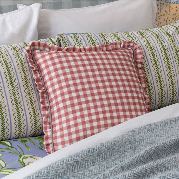 Rose pink Maude Gingham reversible piped cushion from Riva Home, showcasing soft, cozy fabric with piping detail on both sides.