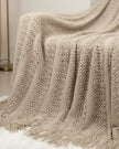 Riva Home beige lightweight throw blanket made of soft furnishings fabric, neutral cream color, cozy and versatile for home decor.