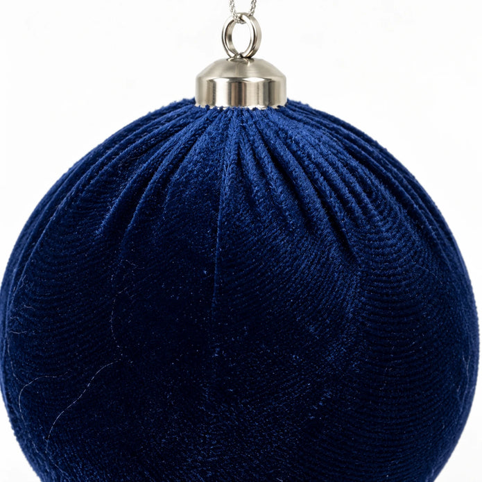 Close-up of a royal-blue velvet Christmas bauble by Starlight Express, showcasing its soft velvet texture and festive design.