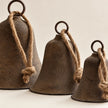 Close-up of the flared rims mottled patina and graduated sizes of rustic brass-coloured bells