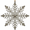 Close-up of distressed metal snowflake with central star and decorative openwork on white.