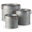 Three empty rustic zinc honeycomb planter pots in graduated sizes with brown ring handles on a white background