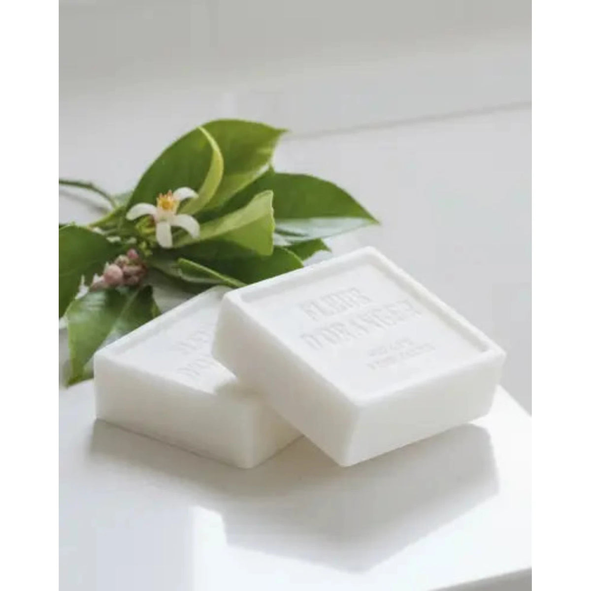 Rustic soap block with fleur d’oranger scent, used as a home fragrance by Terrace & Garden Ltd, shown in a natural setting.